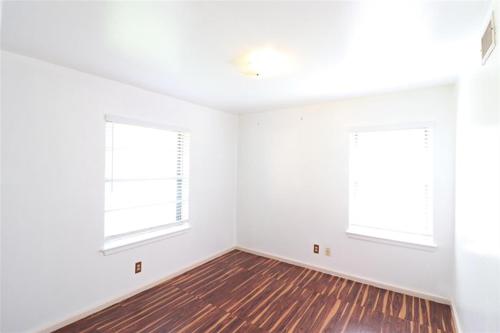 9107 Rustown Drive Dallas, TX 75228 - Photo 17 of 30 a view of an empty room with wooden floor and a window