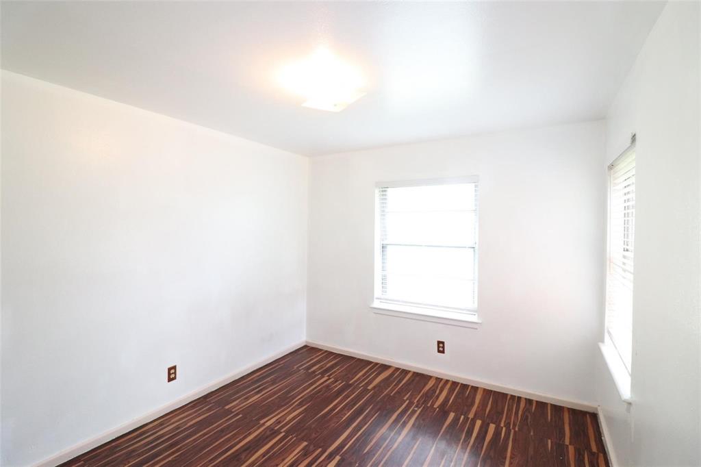 9107 Rustown Drive Dallas, TX 75228 - Photo 19 of 30 a view of an empty room with wooden floor and a window