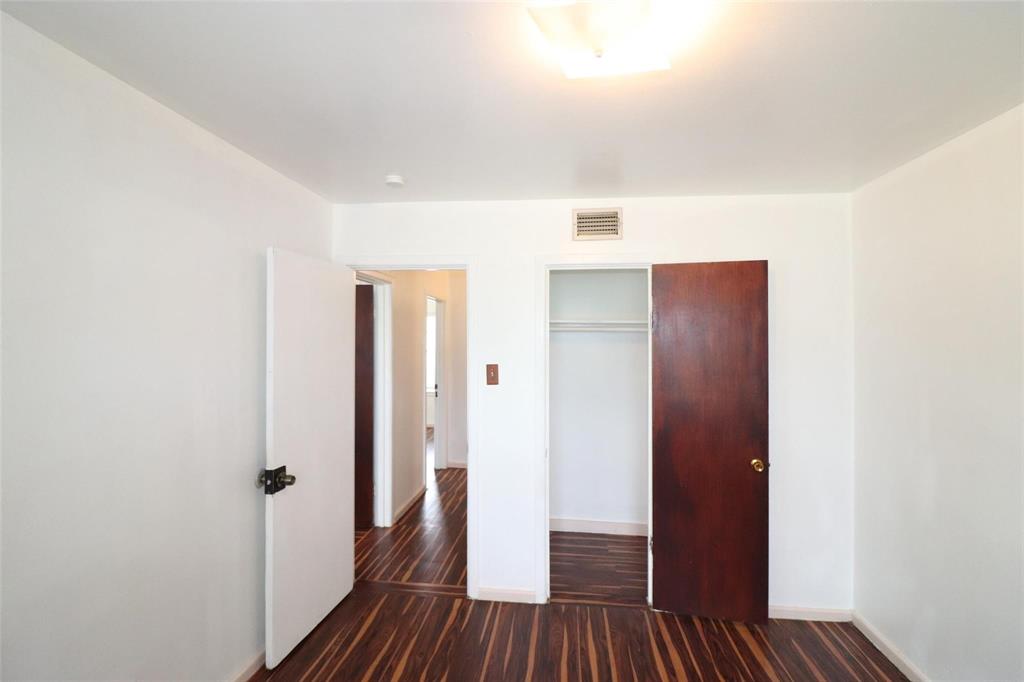 9107 Rustown Drive Dallas, TX 75228 - Photo 20 of 30 a view of a hallway with wooden floor