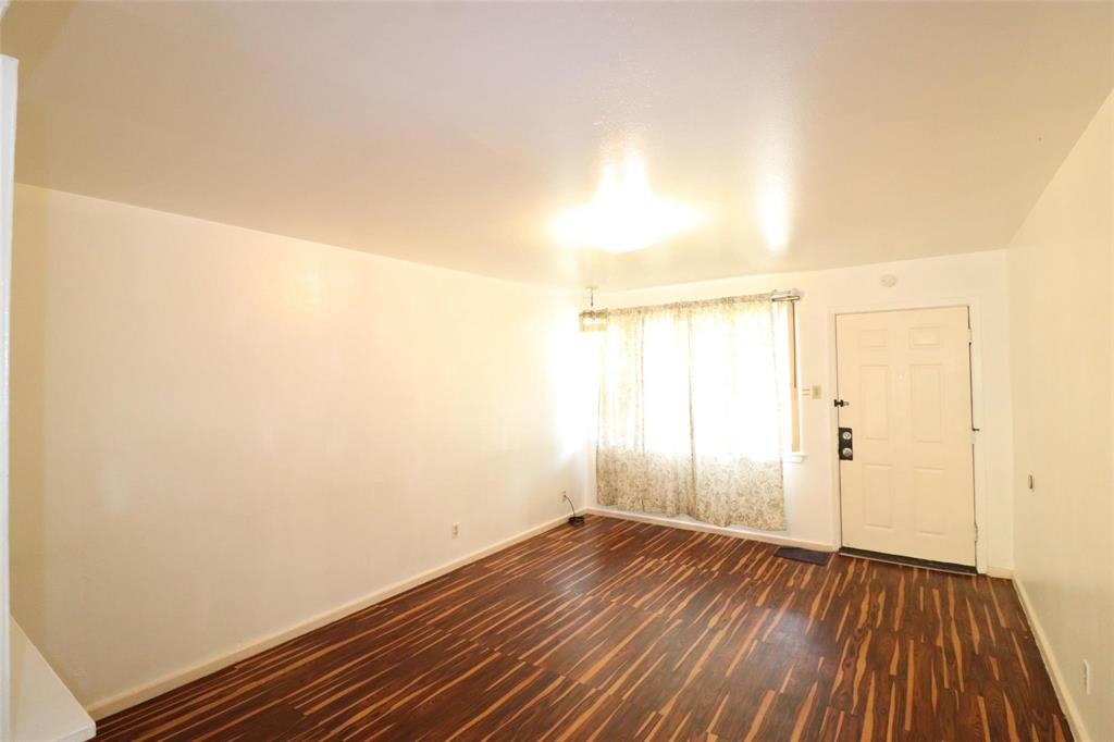 9107 Rustown Drive Dallas, TX 75228 - Photo 21 of 30 an empty room with wooden floor and windows