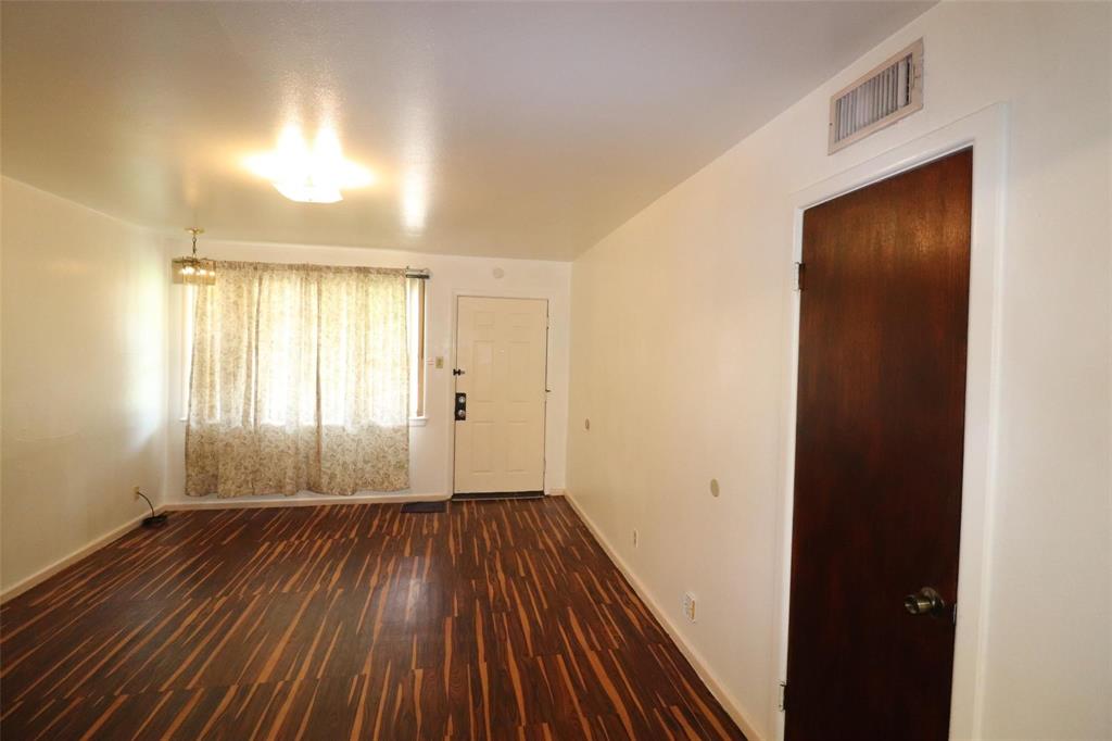9107 Rustown Drive Dallas, TX 75228 - Photo 22 of 30 an empty room with wooden floor and windows