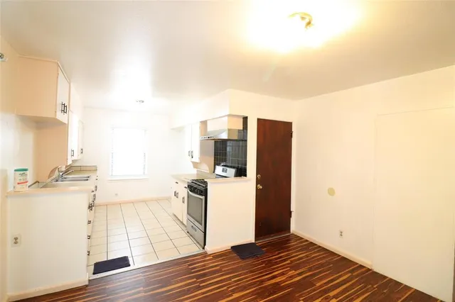 a view of a kitchen with wooden floor