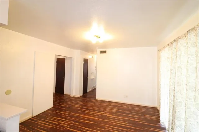 a view of a room with wooden floor and doors