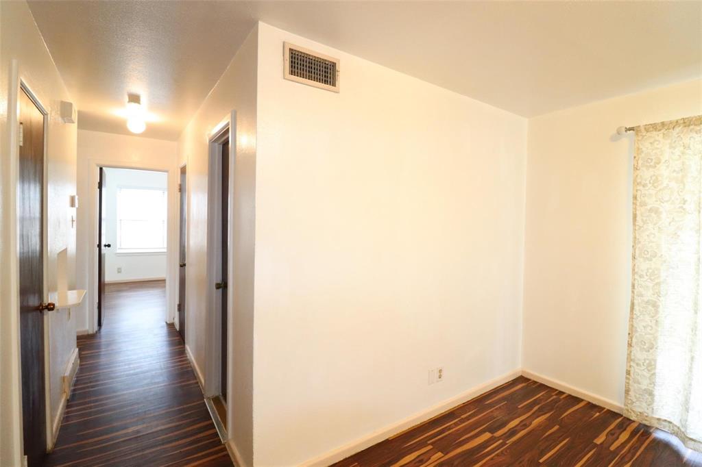 9107 Rustown Drive Dallas, TX 75228 - Photo 8 of 30 a view of a hallway with wooden floor