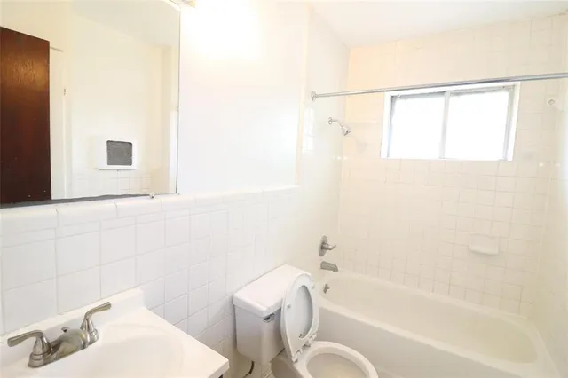 a bathroom with a sink a toilet and bathtub