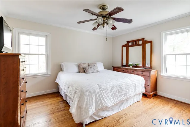 a bedroom with a bed and a flat tv screen on dresser