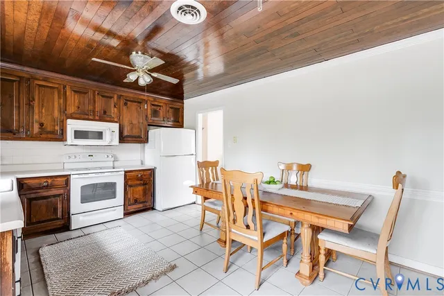 a kitchen with a stove a refrigerator and a stove with wooden floor