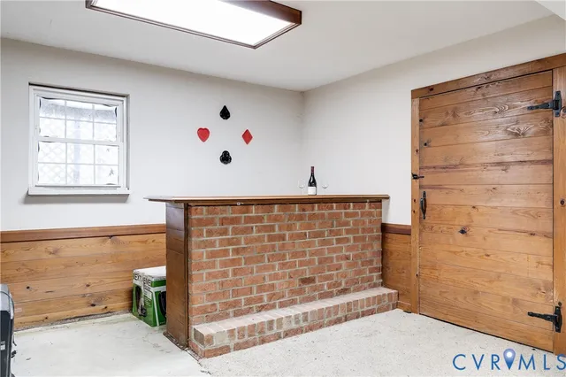 a backyard of a house with large trees and outdoor seating