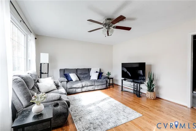 a living room with furniture and wooden floor