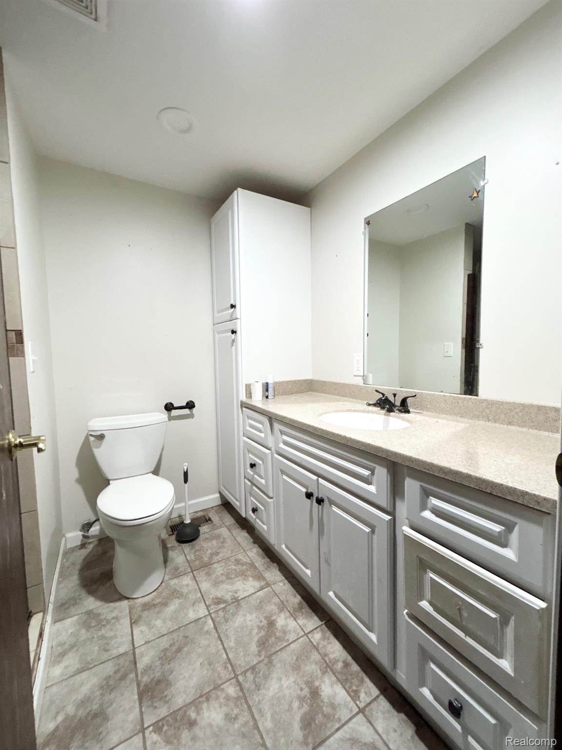 140 Larson Road Attica, MI 48412 - Photo 25 of 41 Bathroom featuring a white vanity with paneling, integrated sink, and an expansive countertop