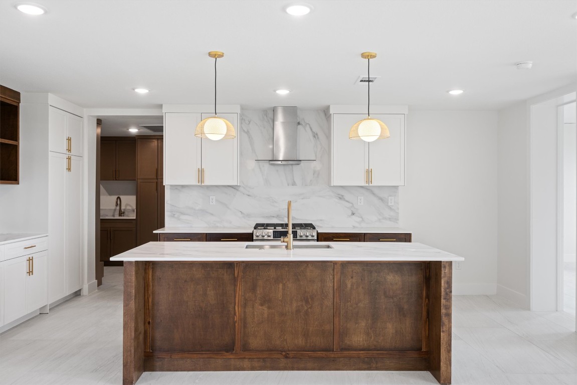 109 Fall Drive Georgetown, TX 78633 - Photo 11 of 40 a large kitchen with kitchen island stainless steel appliances sink and wooden floor