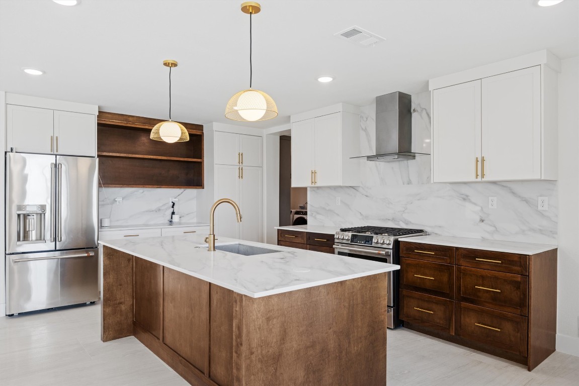 109 Fall Drive Georgetown, TX 78633 - Photo 14 of 40 a kitchen with a sink a counter space appliances and cabinets