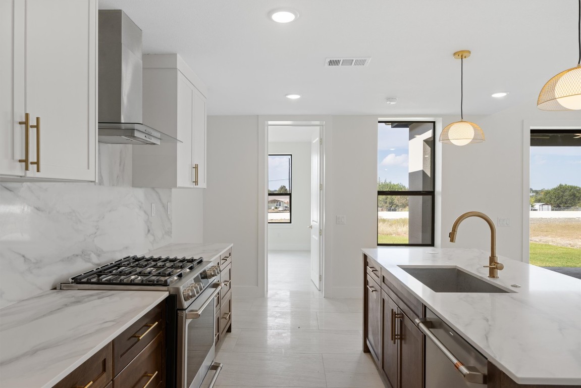 109 Fall Drive Georgetown, TX 78633 - Photo 15 of 40 a kitchen with stainless steel appliances granite countertop a sink stove and cabinets