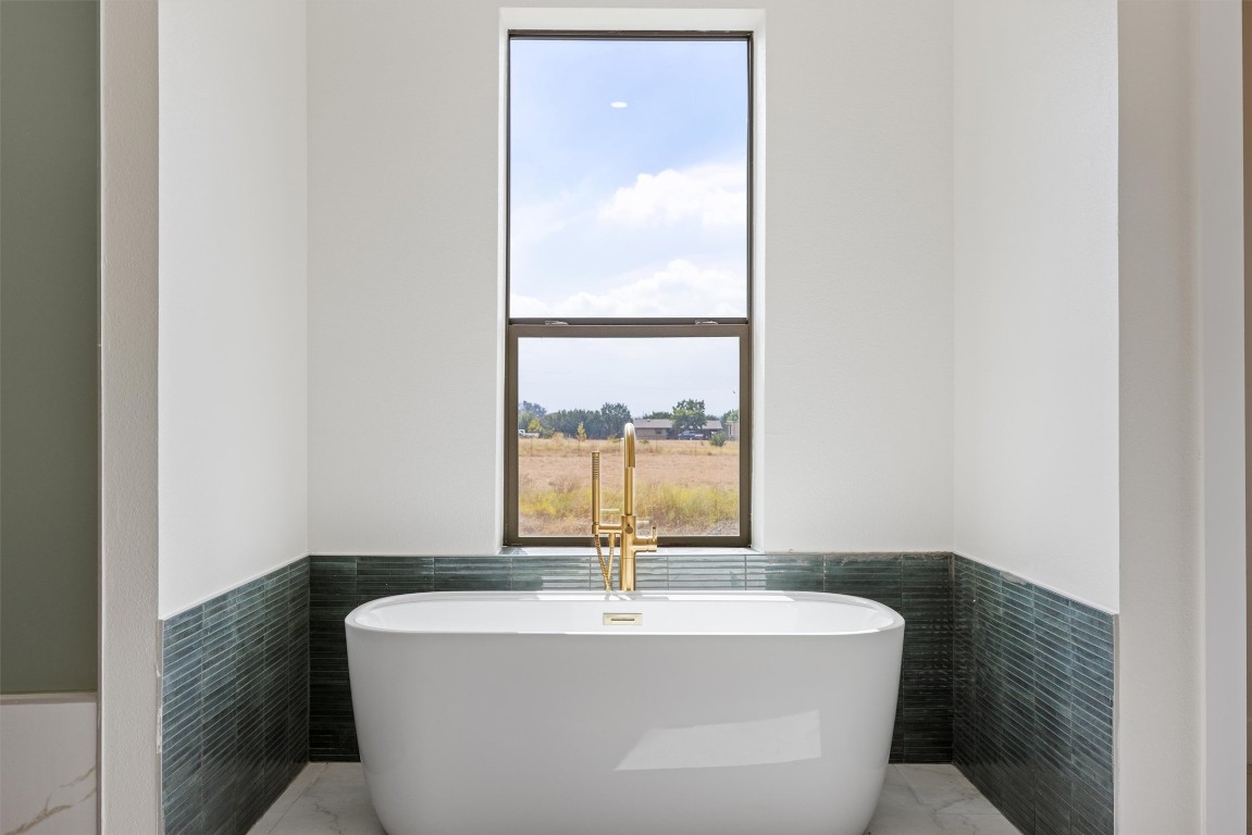 109 Fall Drive Georgetown, TX 78633 - Photo 20 of 40 a bath tub sitting in a bathroom next to a window