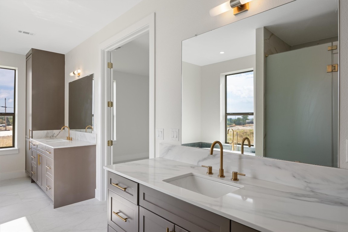 109 Fall Drive Georgetown, TX 78633 - Photo 21 of 40 a bathroom with a sink double vanity and a mirror