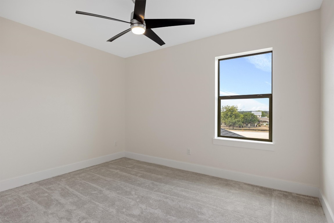 109 Fall Drive Georgetown, TX 78633 - Photo 31 of 40 an empty room with a window and a ceiling fan