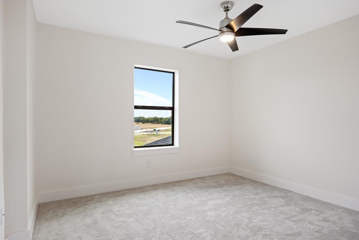109 Fall Drive Georgetown, TX 78633 - Photo 33 of 40 an empty room with a window and a fan