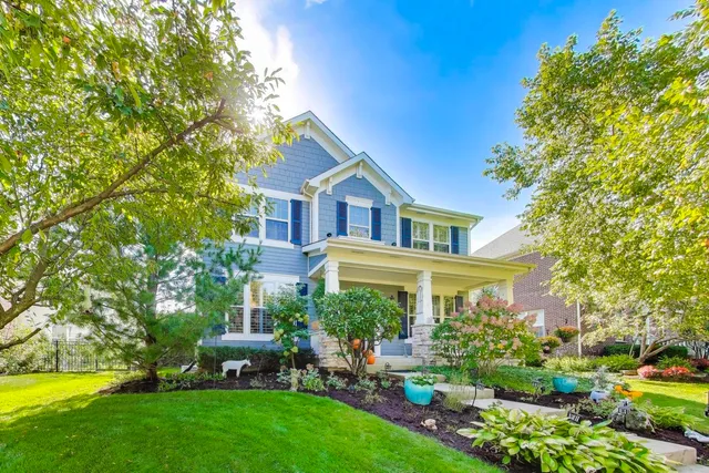 a front view of a house with garden and porch