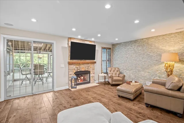 a living room with furniture a fireplace and a flat screen tv