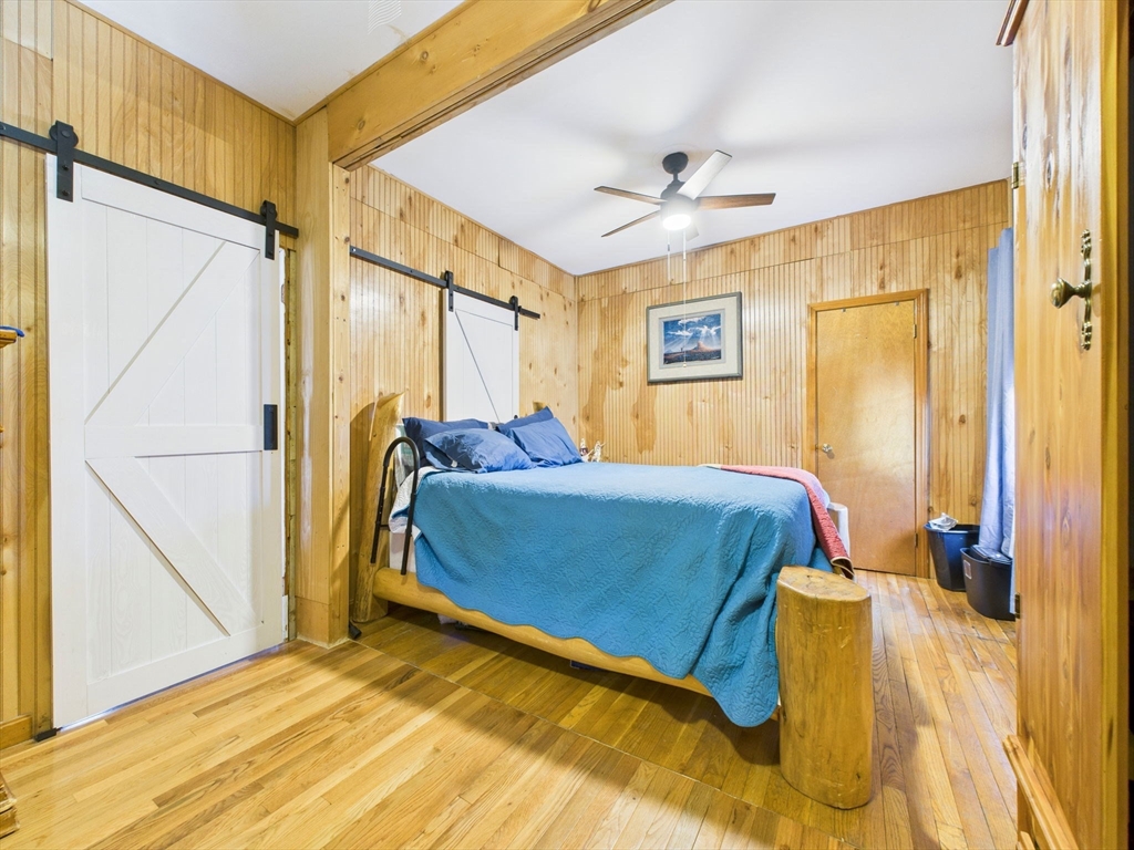 371 Reed Street New Bedford, MA 02740 - Photo 12 of 42 a bedroom with a bed and wooden floor