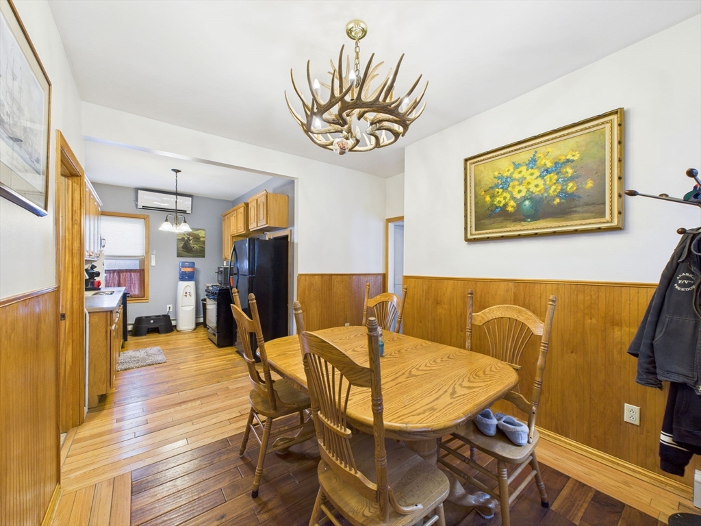 371 Reed Street New Bedford, MA 02740 - Photo 20 of 42 a view of a dining room with furniture a chandelier and wooden floor