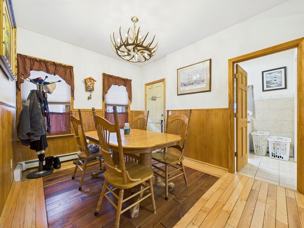371 Reed Street New Bedford, MA 02740 - Photo 21 of 42 a view of a dining room with furniture wooden floor and a chandelier
