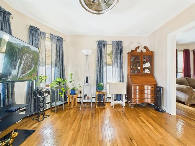 a living room with furniture a window and a table
