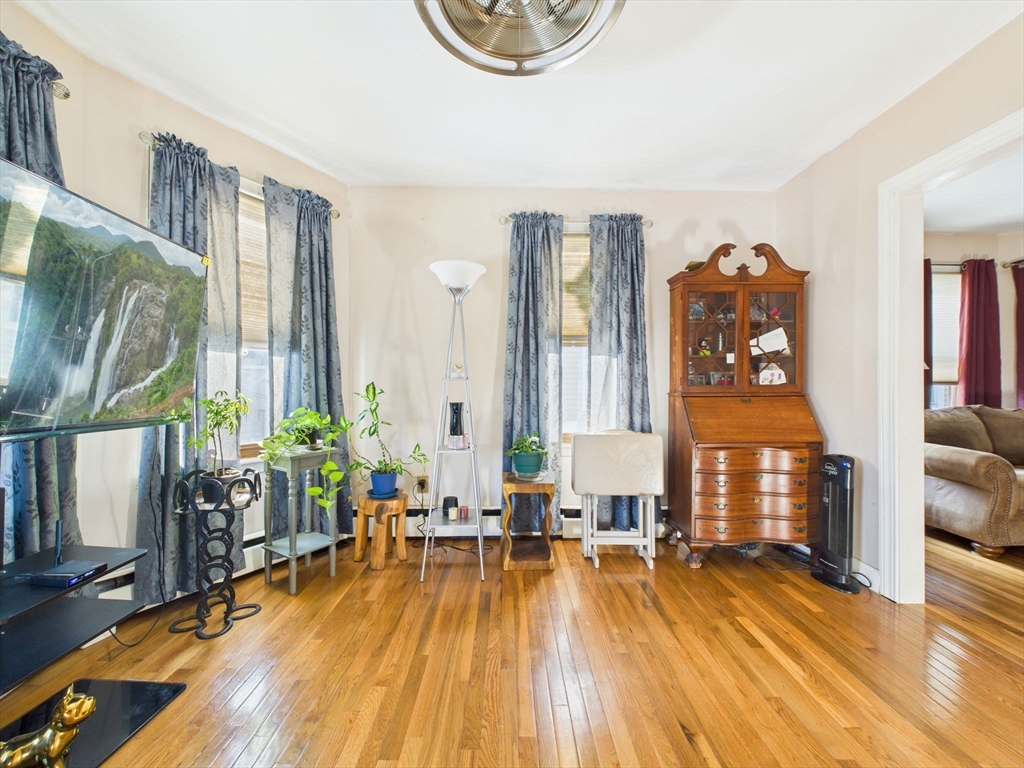 371 Reed Street New Bedford, MA 02740 - Photo 26 of 42 a living room with furniture and wooden floor
