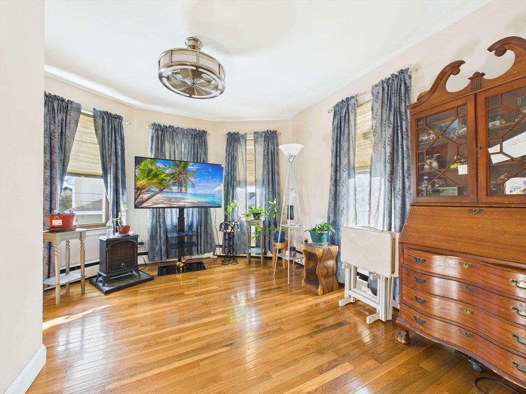 371 Reed Street New Bedford, MA 02740 - Photo 27 of 42 a living room with furniture a window and a table