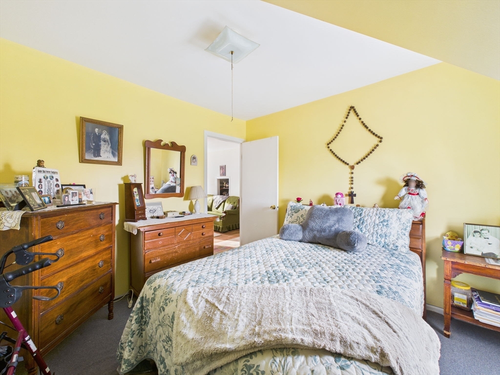 371 Reed Street New Bedford, MA 02740 - Photo 37 of 42 a bedroom with a bed and wooden floor