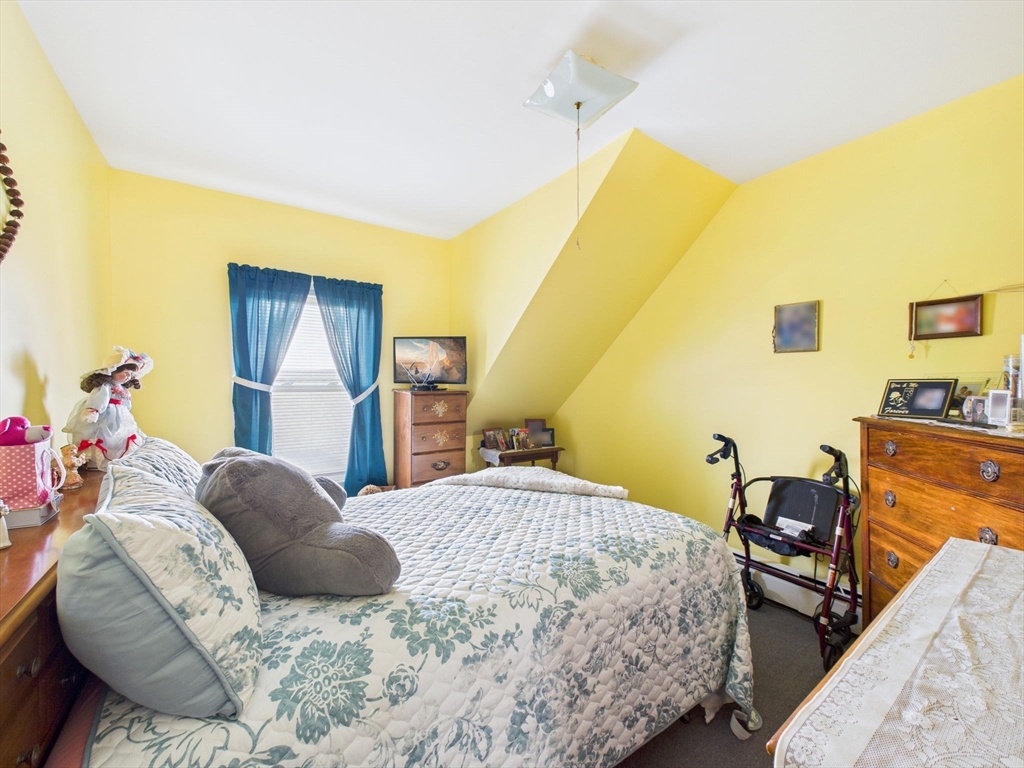371 Reed Street New Bedford, MA 02740 - Photo 38 of 42 a bedroom with a bed and wooden floor