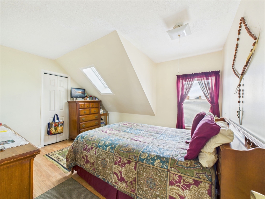 371 Reed Street New Bedford, MA 02740 - Photo 40 of 42 a bedroom with a bed and a window