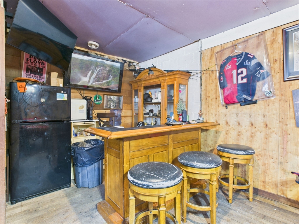 371 Reed Street New Bedford, MA 02740 - Photo 10 of 42 a dining room with a wooden table and chairs
