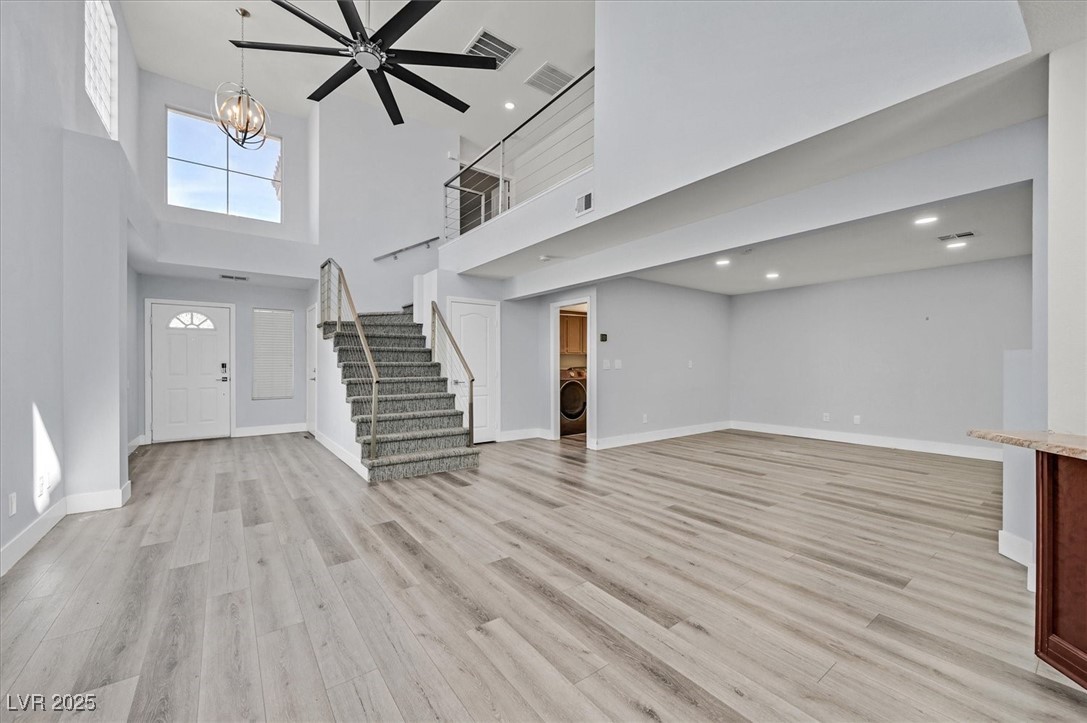 5421 Painted Mirage Road Las Vegas, NV 89149 - Photo 7 of 35 Foyer entrance with light wood-style floors, visible vents, stairway, and baseboards