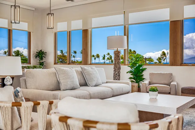 a living room with furniture and a potted plant