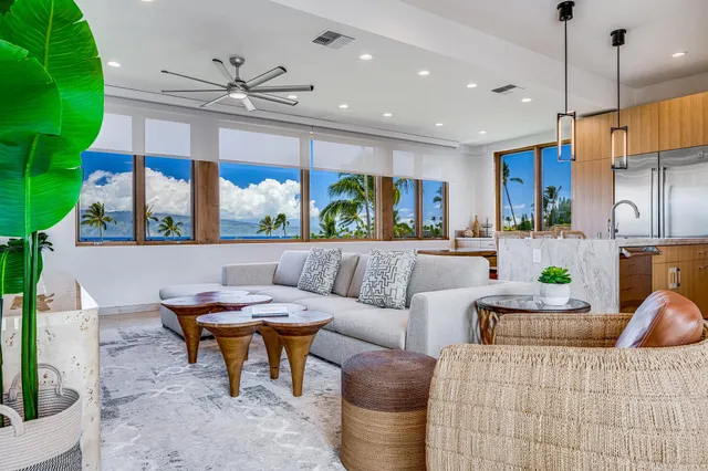 a living room with furniture a chandelier and a flat screen tv