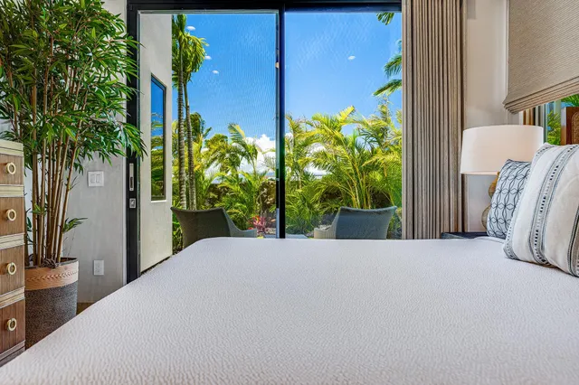 a potted plant sitting in front of a house with a garden