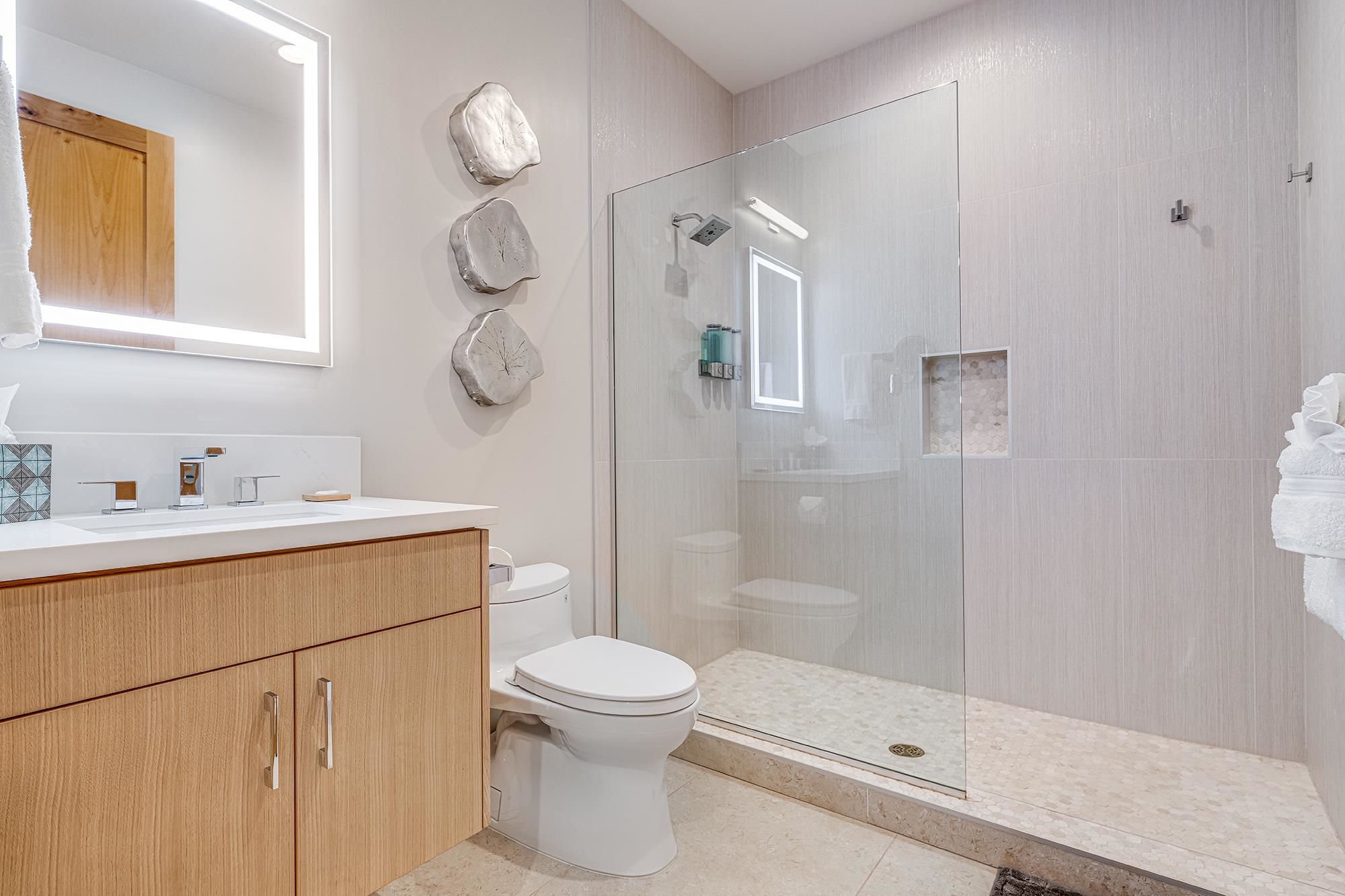 5385 Lower Honoapiilani Road Lahaina, HI 96761 - Photo 24 of 42 a bathroom with a shower sink mirror and toilet