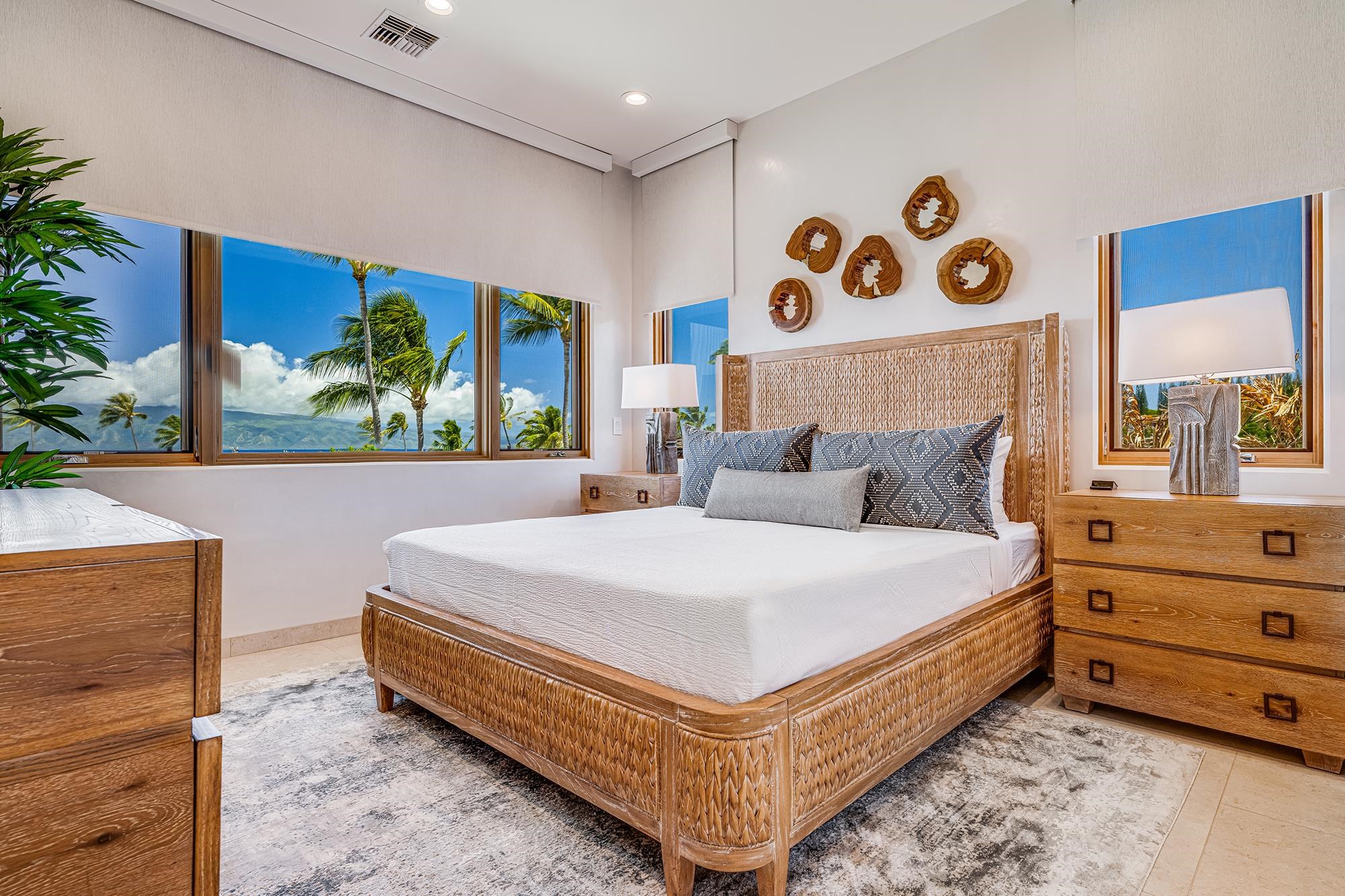 5385 Lower Honoapiilani Road Lahaina, HI 96761 - Photo 27 of 42 a bed room with a bed and a painting on the wall