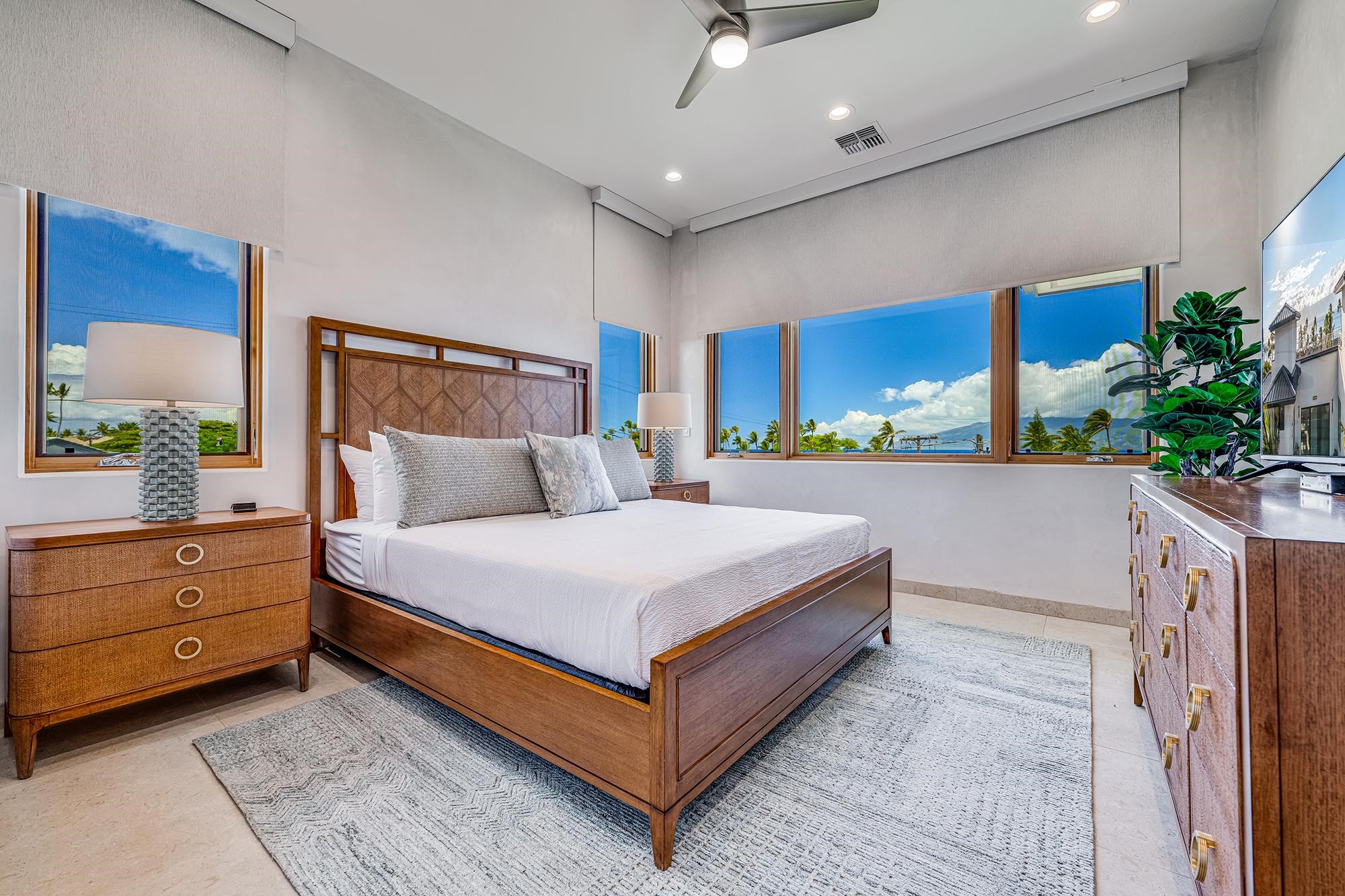 5385 Lower Honoapiilani Road Lahaina, HI 96761 - Photo 28 of 42 a bedroom with a bed and a potted plant on the dresser