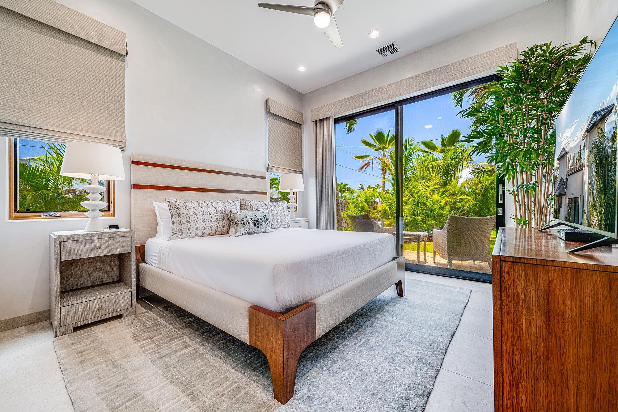 5385 Lower Honoapiilani Road Lahaina, HI 96761 - Photo 30 of 42 a bedroom with a bed and a large window