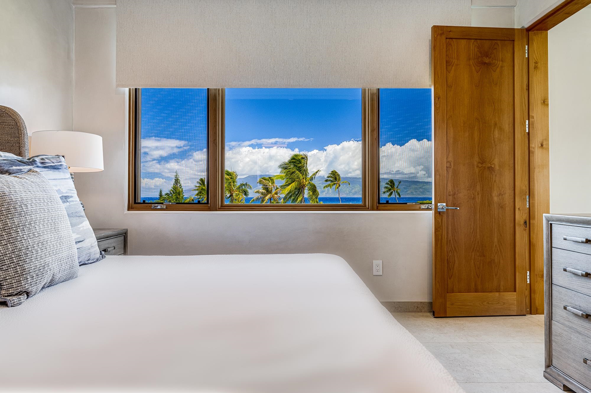 5385 Lower Honoapiilani Road Lahaina, HI 96761 - Photo 31 of 42 a bedroom with a large window and a bed