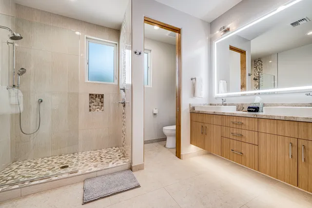 a bathroom with a shower sink and mirror