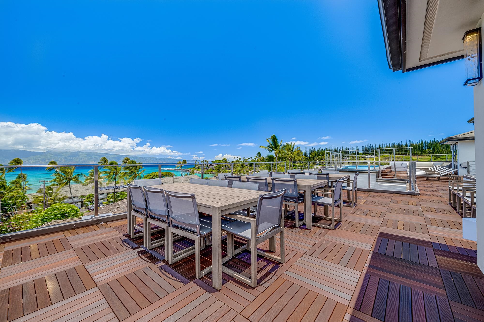5385 Lower Honoapiilani Road Lahaina, HI 96761 - Photo 40 of 42 a view of a patio with table and chairs with wooden floor and fence