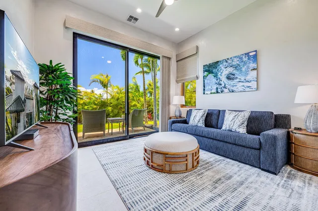 a living room with furniture and a potted plant