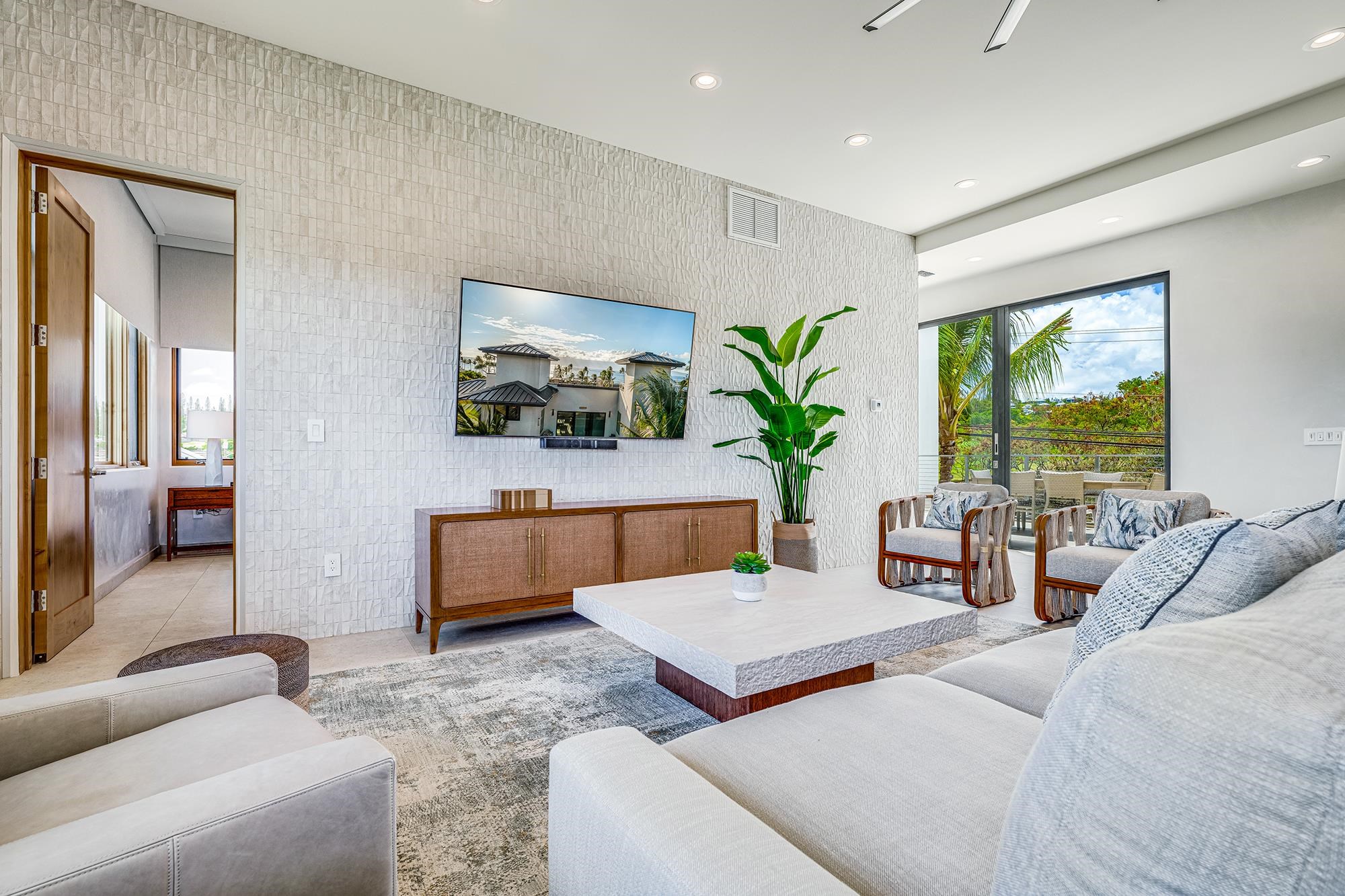 5385 Lower Honoapiilani Road Lahaina, HI 96761 - Photo 10 of 42 a living room with furniture and a flat screen tv