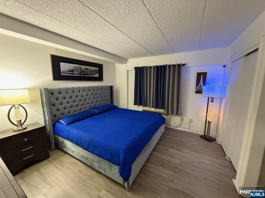 47 Polifly Road, Unit 1D Hackensack, NJ 07601 - Photo 4 of 8 a bedroom with a bed and a dresser