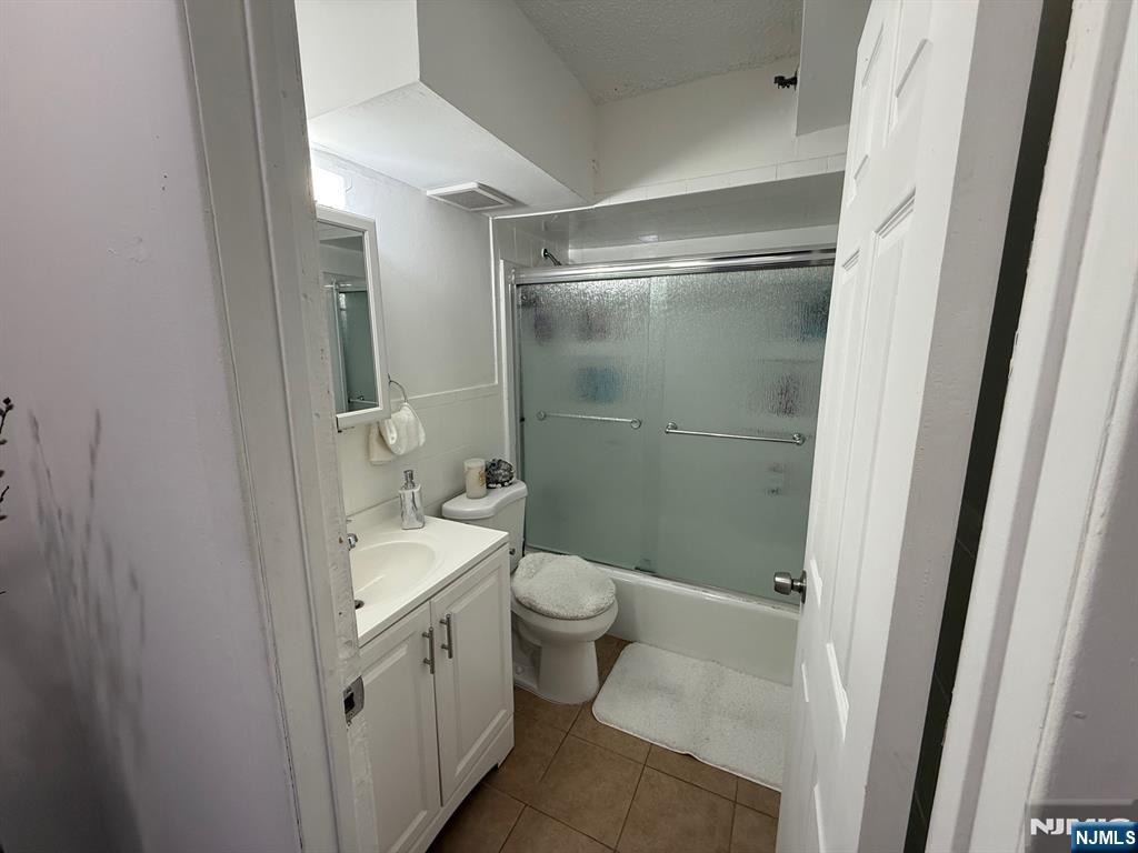 47 Polifly Road, Unit 1D Hackensack, NJ 07601 - Photo 5 of 8 a bathroom with a sink a toilet and shower