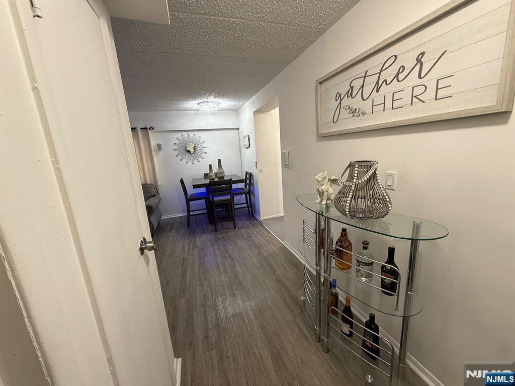 47 Polifly Road, Unit 1D Hackensack, NJ 07601 - Photo 6 of 8 a view of a hallway with wooden floor and stairs