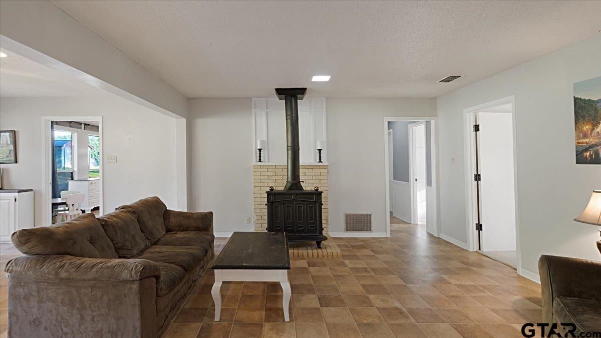 8192 County Road 428 Tyler, TX 75704 - Photo 10 of 38 a living room with furniture and a fireplace